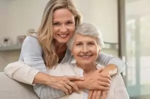 A daughter giving her mother an embrace.
