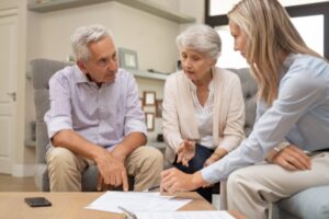 An elderly couple discussing estate litigation with their attorney in Long Island.