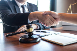 A handshake between a lawyer handling estate planning matters and his client.