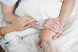 woman-holding-a-hand-of-a-sick-elderly