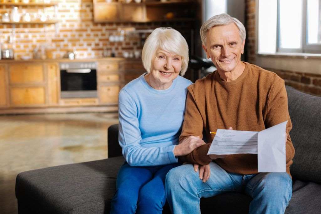 An elderly couple happy about the wills and trusts legal assistance from a lawyer in Long Island.