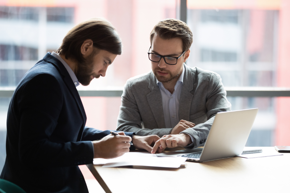 Attorney guiding client through paperwork related to does a will avoid a probate